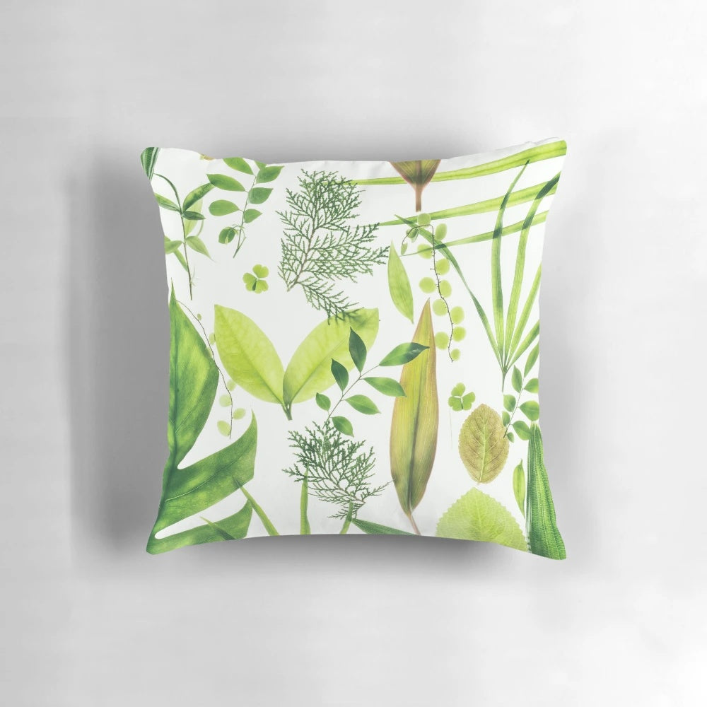 Closeup of a lush, translucent green foliage pillow with a botanical, nature-inspired design.