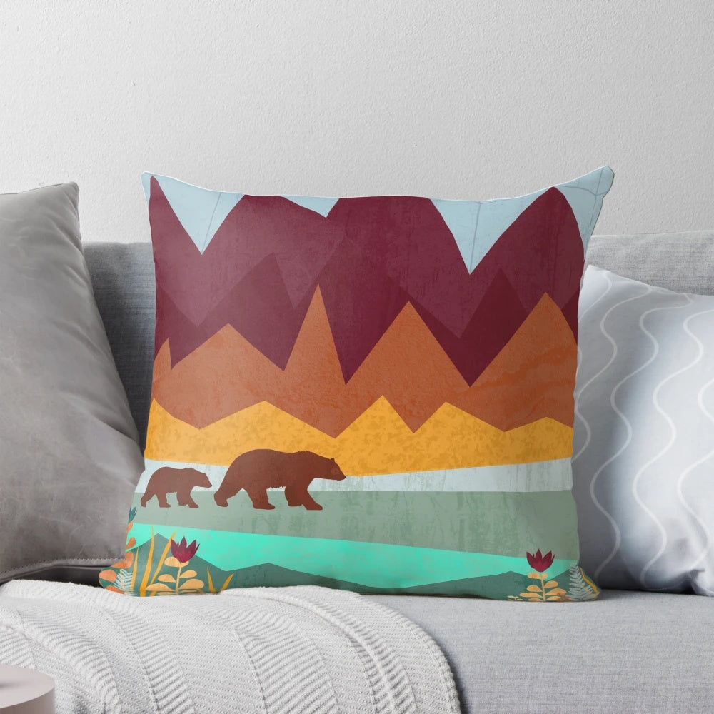 A vibrant, nature-inspired pillow featuring a mother bear and her cub in a scenic mountain landscape.