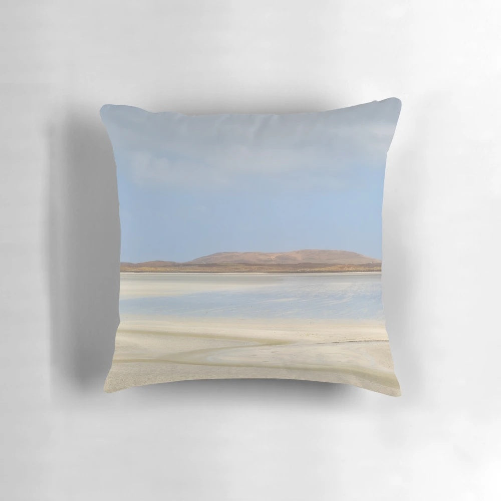 Serene view of the sandy Vallay Strand beach in North Uist, Scotland, with rolling hills and the sea in the background.