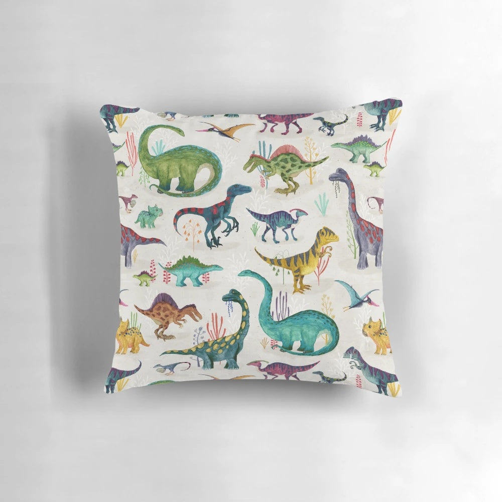 Vibrant dinosaur-themed pillow with various prehistoric plant-eating dinosaurs in blue, green, yellow, pink, and red colors