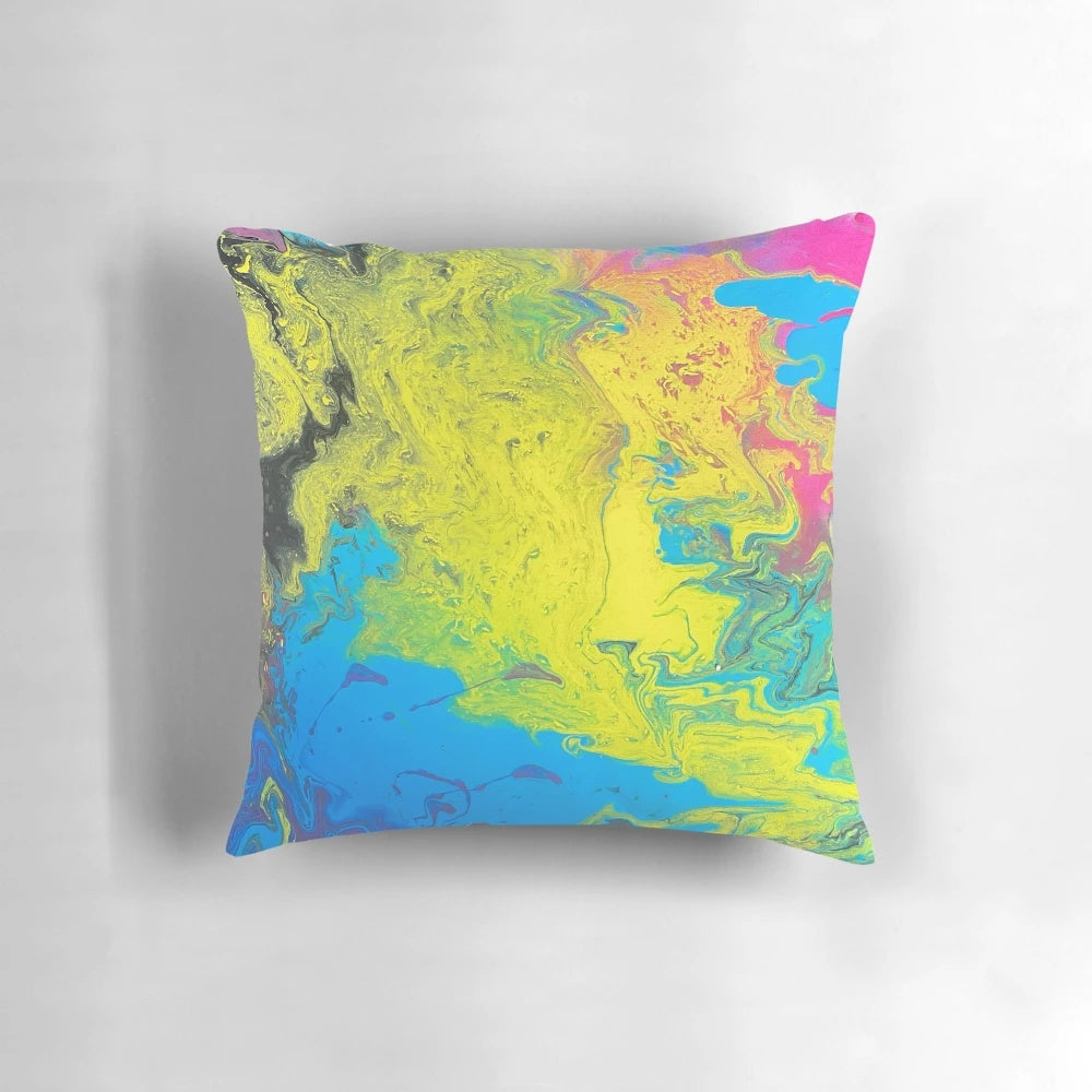 Bright and colorful pillow with shades of yellow, blue, and pink for a vibrant home accent.