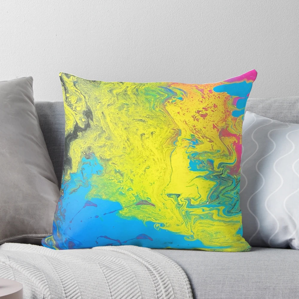 Bright and colorful pillow with shades of yellow, blue, and pink for a vibrant home accent.