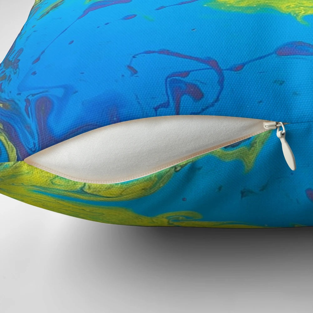 Bright and colorful pillow with shades of yellow, blue, and pink for a vibrant home accent.