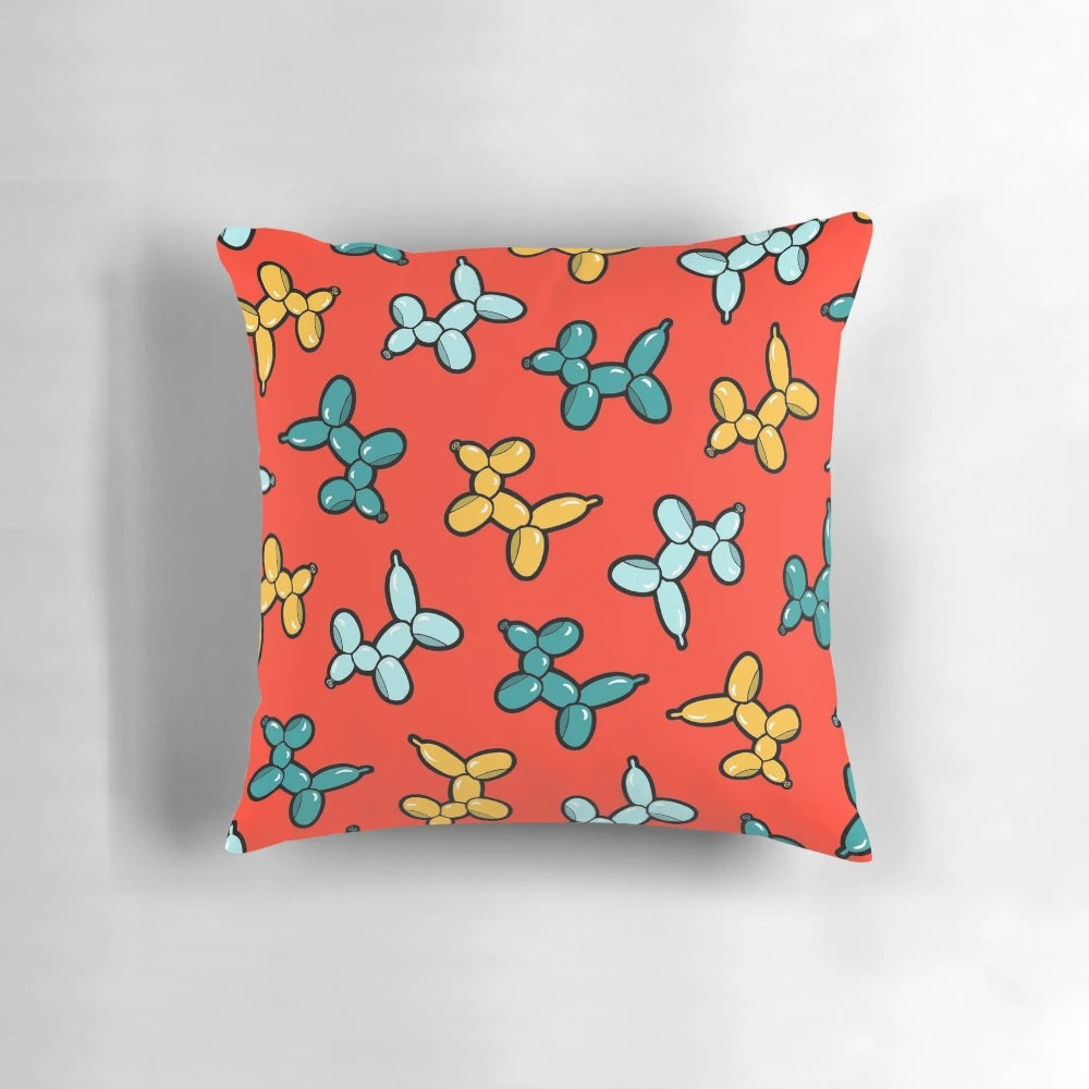 Colorful pillow with a repeating pattern of illustrated balloon animal dogs in red, yellow, and blue