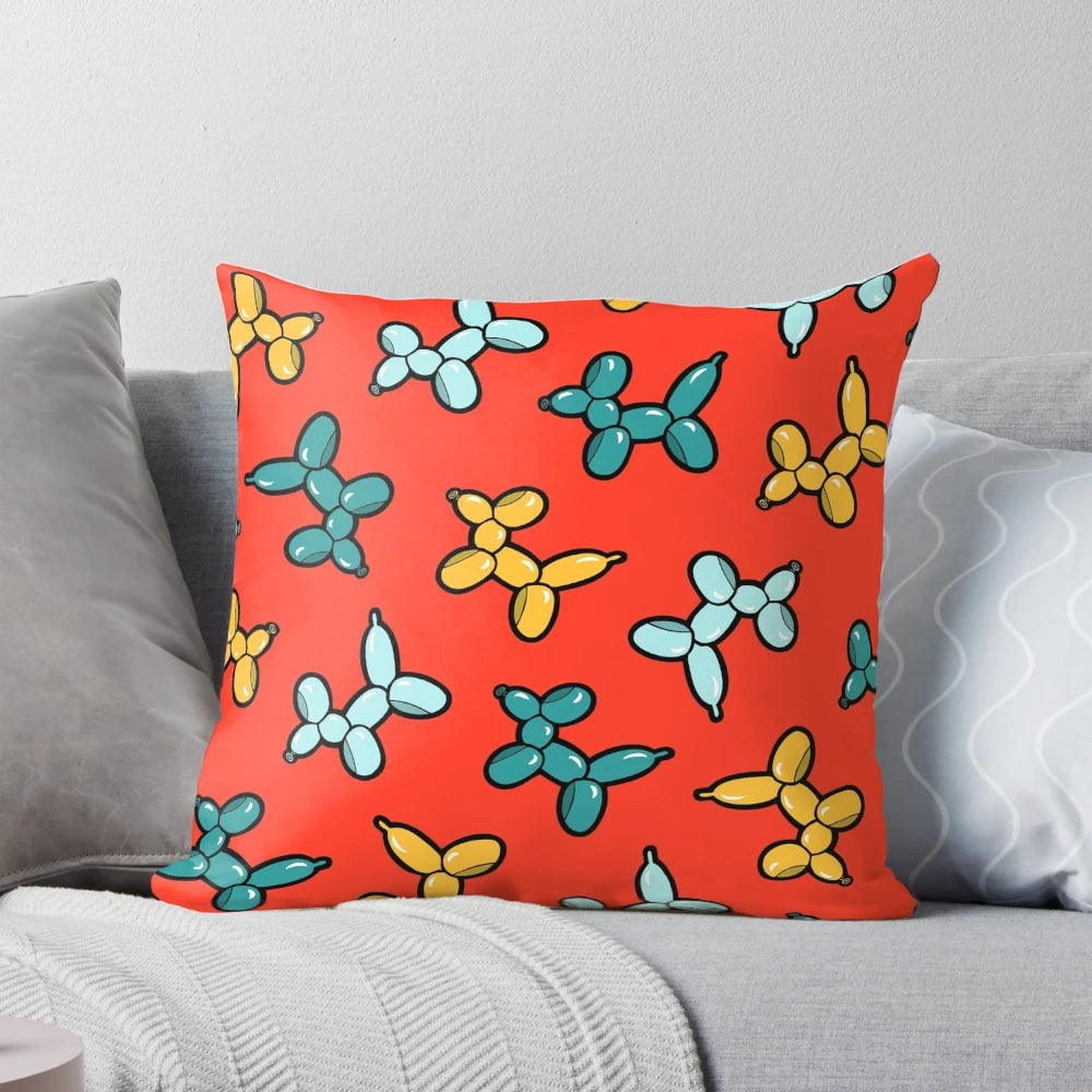 Colorful pillow with a repeating pattern of illustrated balloon animal dogs in red, yellow, and blue