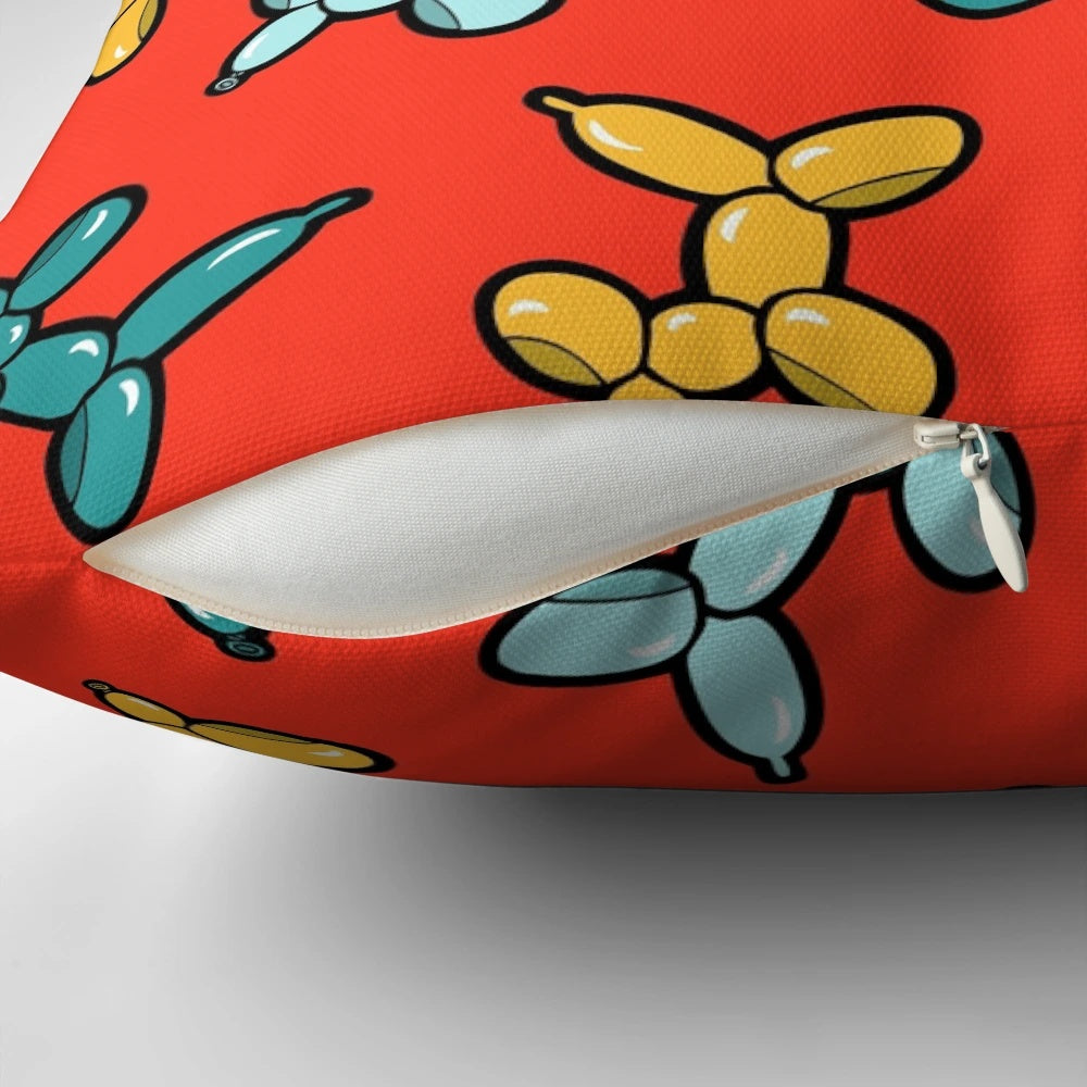 Colorful pillow with a repeating pattern of illustrated balloon animal dogs in red, yellow, and blue