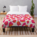Soft and cozy leopard print plush blanket in vibrant hot pink and orange colors