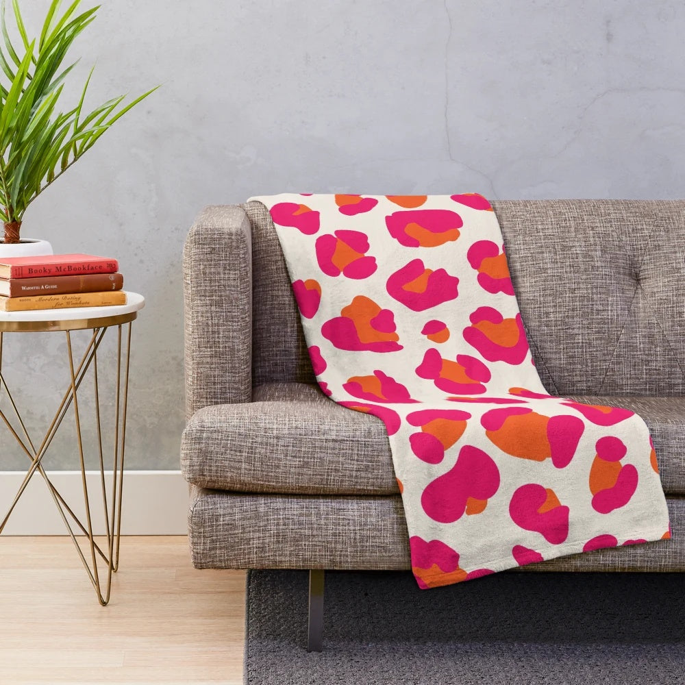 Soft and cozy leopard print plush blanket in vibrant hot pink and orange colors