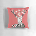 A bright and festive reindeer Christmas pillow with white snow and twinkling lights.