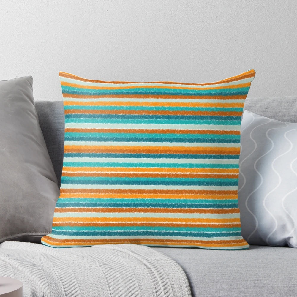 A vibrant and textured summer striped pillow in shades of orange, rust, turquoise, teal, and white.