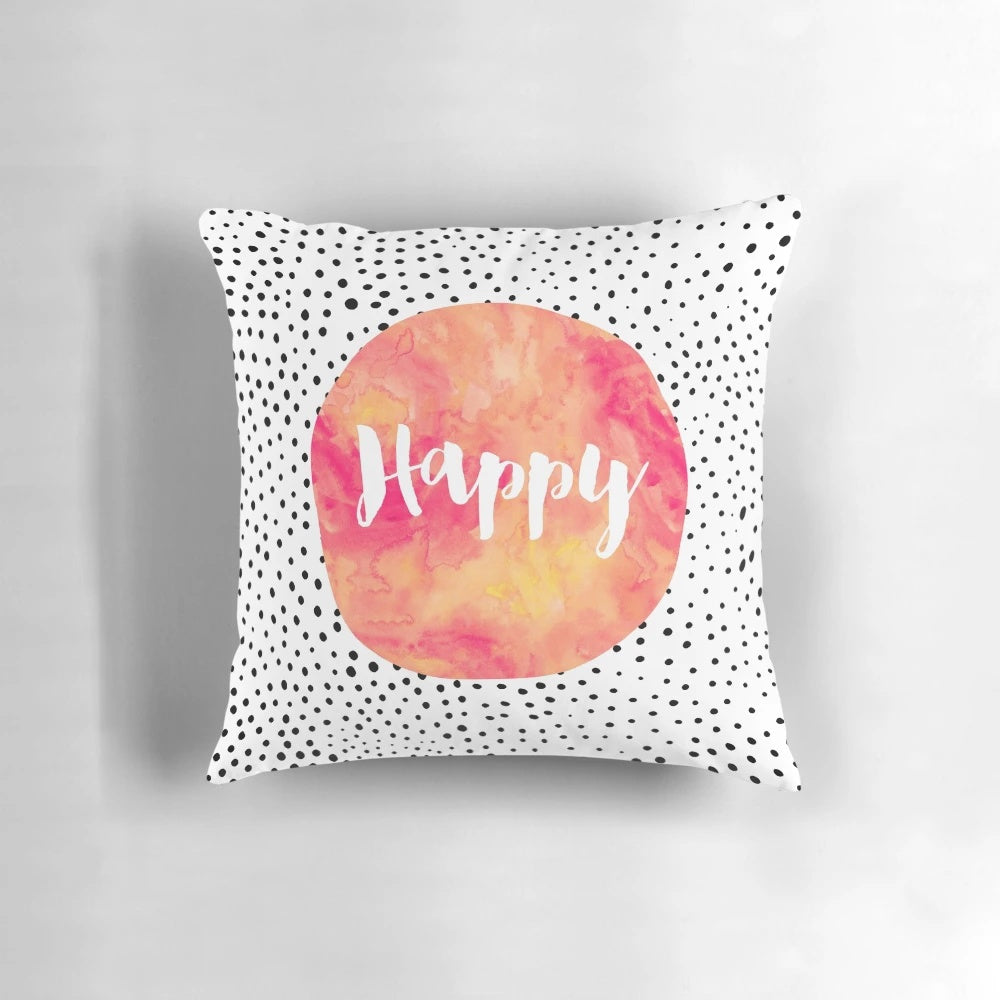 A colorful pillow with a happy, inspirational quote and playful polka dots design