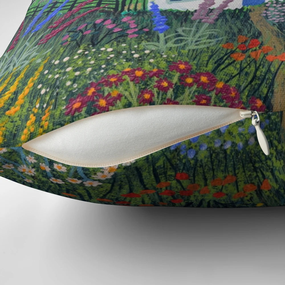 A decorative pillow featuring a serene lighthouse scene against a backdrop of a white cottage, lush gardens, and the sea.