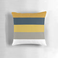 Broad stripes pattern in mustard yellow, grey, and navy blue on a modern, minimalist pillow