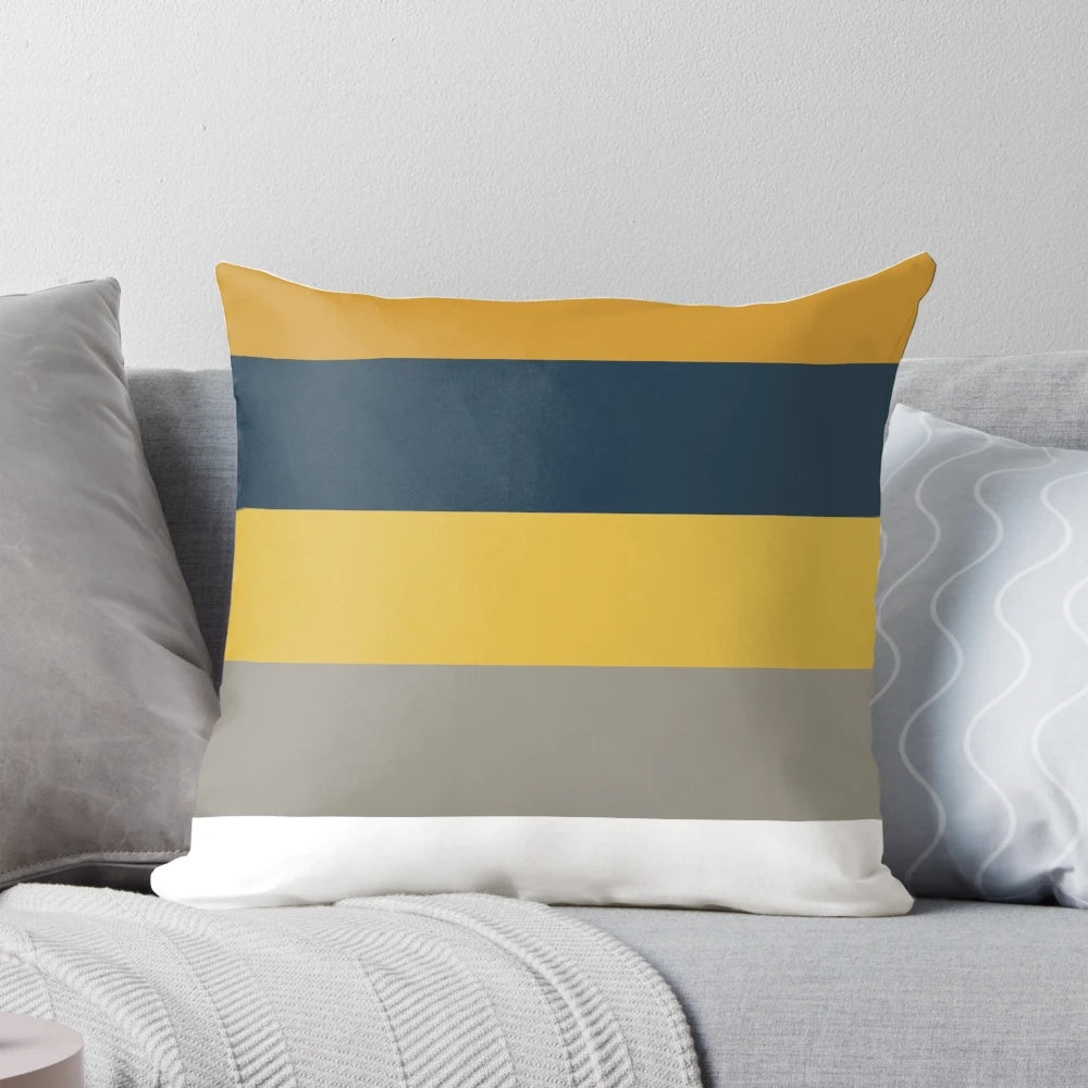 Broad stripes pattern in mustard yellow, grey, and navy blue on a modern, minimalist pillow