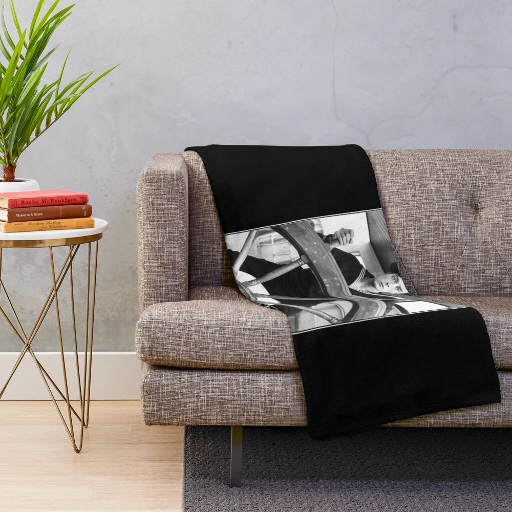 Buster Keaton in his iconic movie The Navigator, in black and white, on a plush blanket