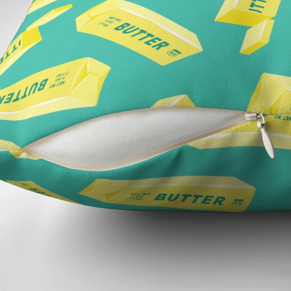 Teal pillow featuring a butter design, perfect for butter lovers and kitchen decor