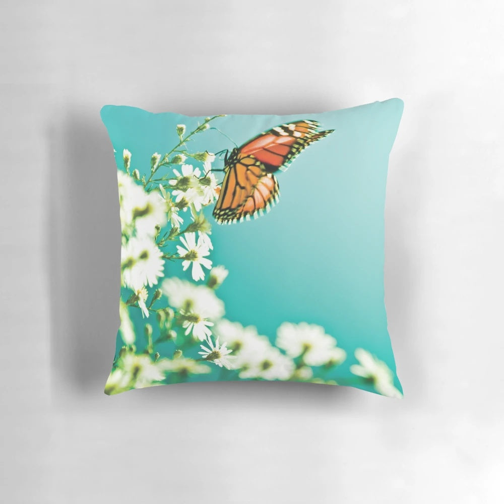 Beautifully designed throw pillow featuring a butterfly and flowers in a nature-inspired pattern.
