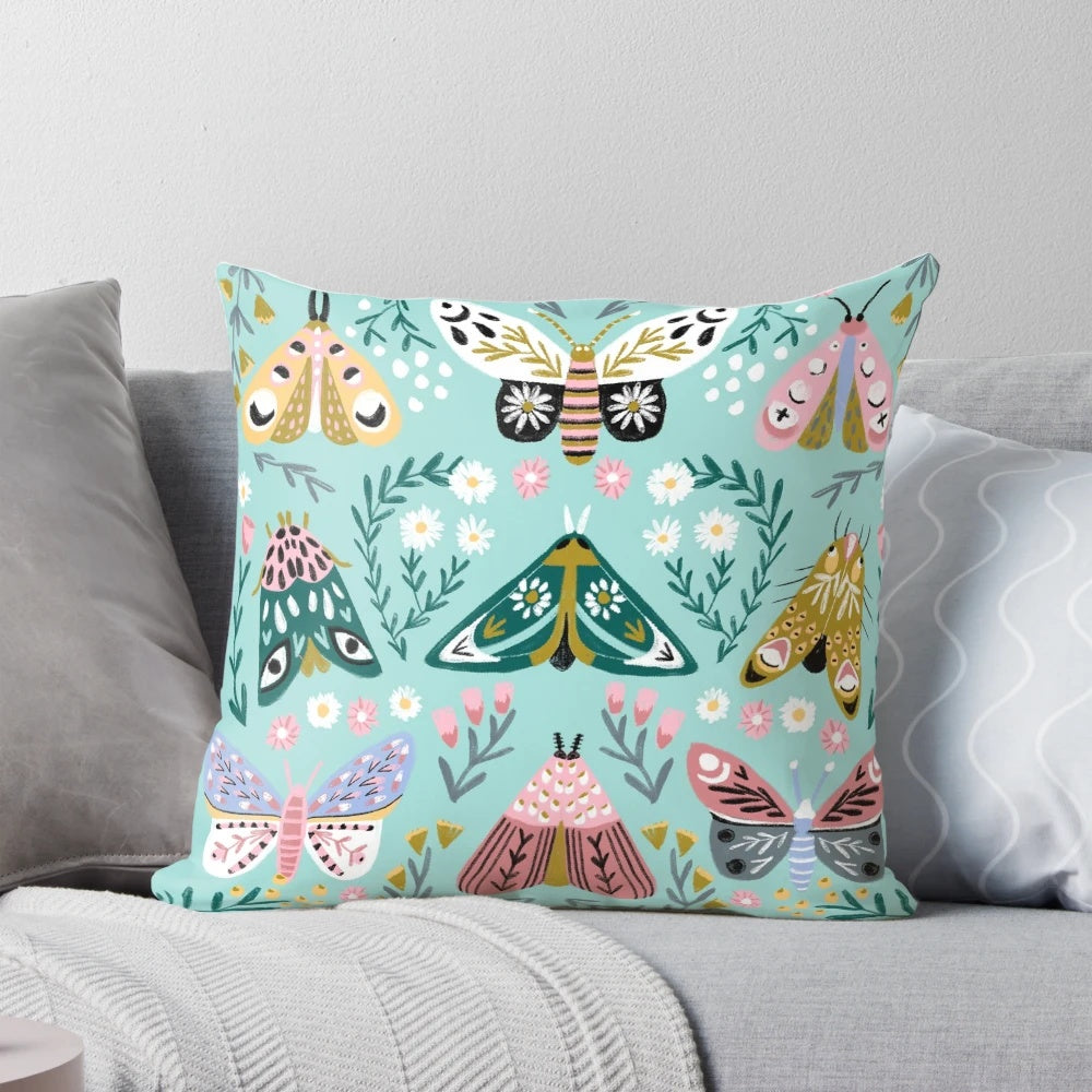 Vibrant butterfly garden design featuring colorful daisies, roses, and butterflies on a decorative pillow.