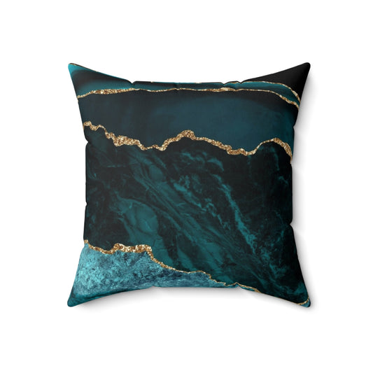 Teal and gold agate-inspired decorative pillow with a geode-like texture