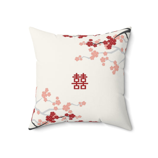 A decorative pillow featuring vibrant red cherry blossoms and oriental design elements.