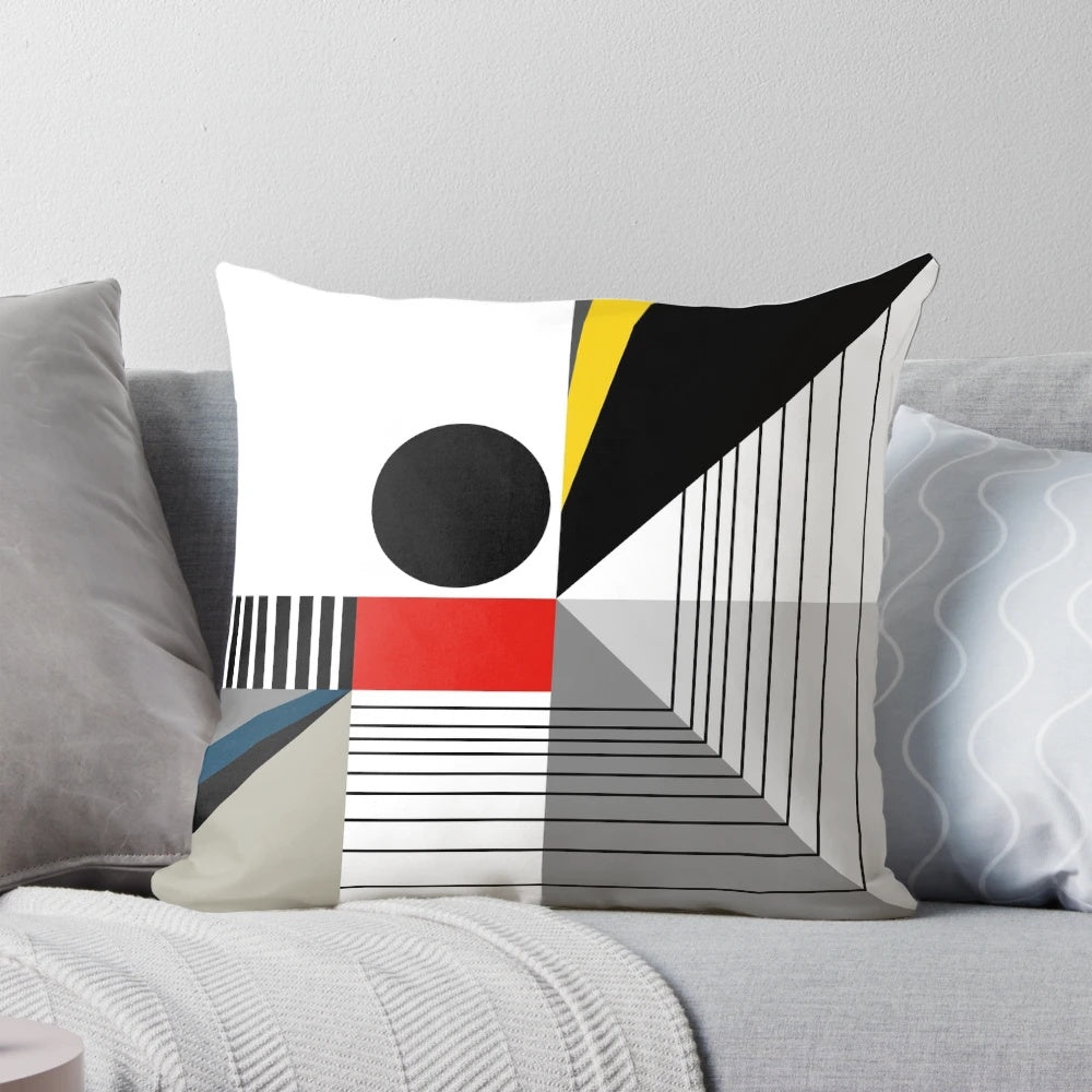 A black and white abstract geometric pillow with red and yellow accents, showcasing a modern Bauhaus-inspired design.