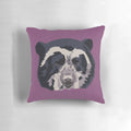 A close-up portrait of an adorable Andean or spectacled bear face printed on a high-quality pillow.