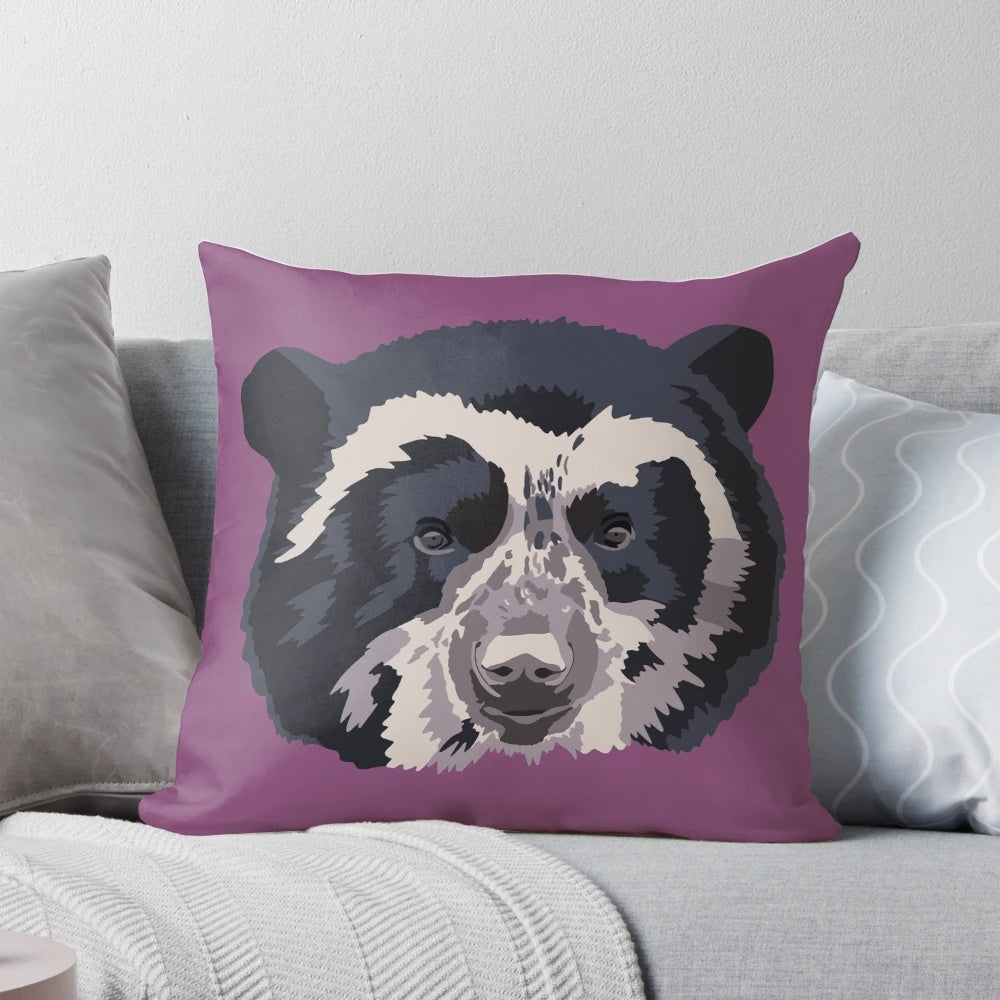 A close-up portrait of an adorable Andean or spectacled bear face printed on a high-quality pillow.