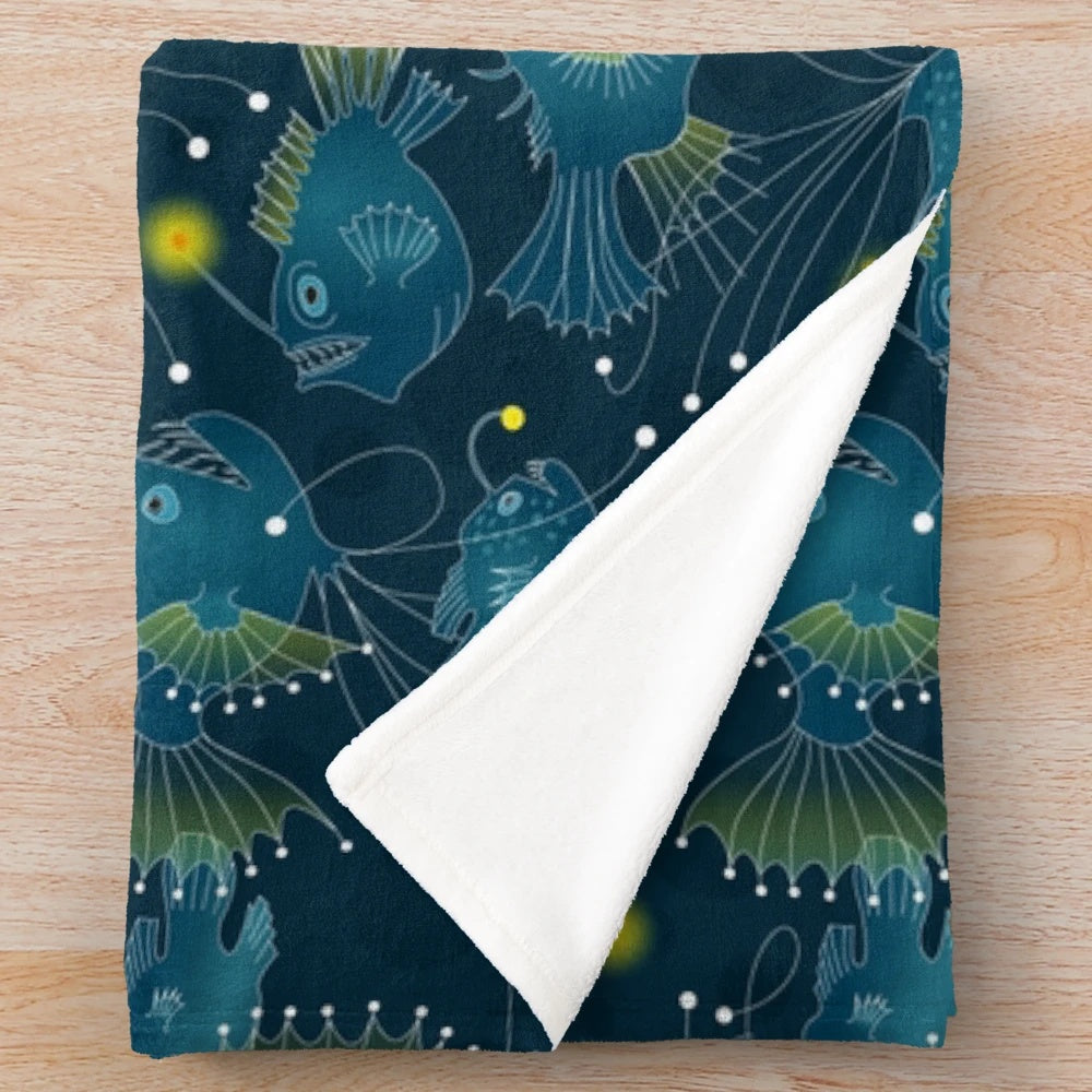 Soft plush blanket featuring a detailed angler fish design