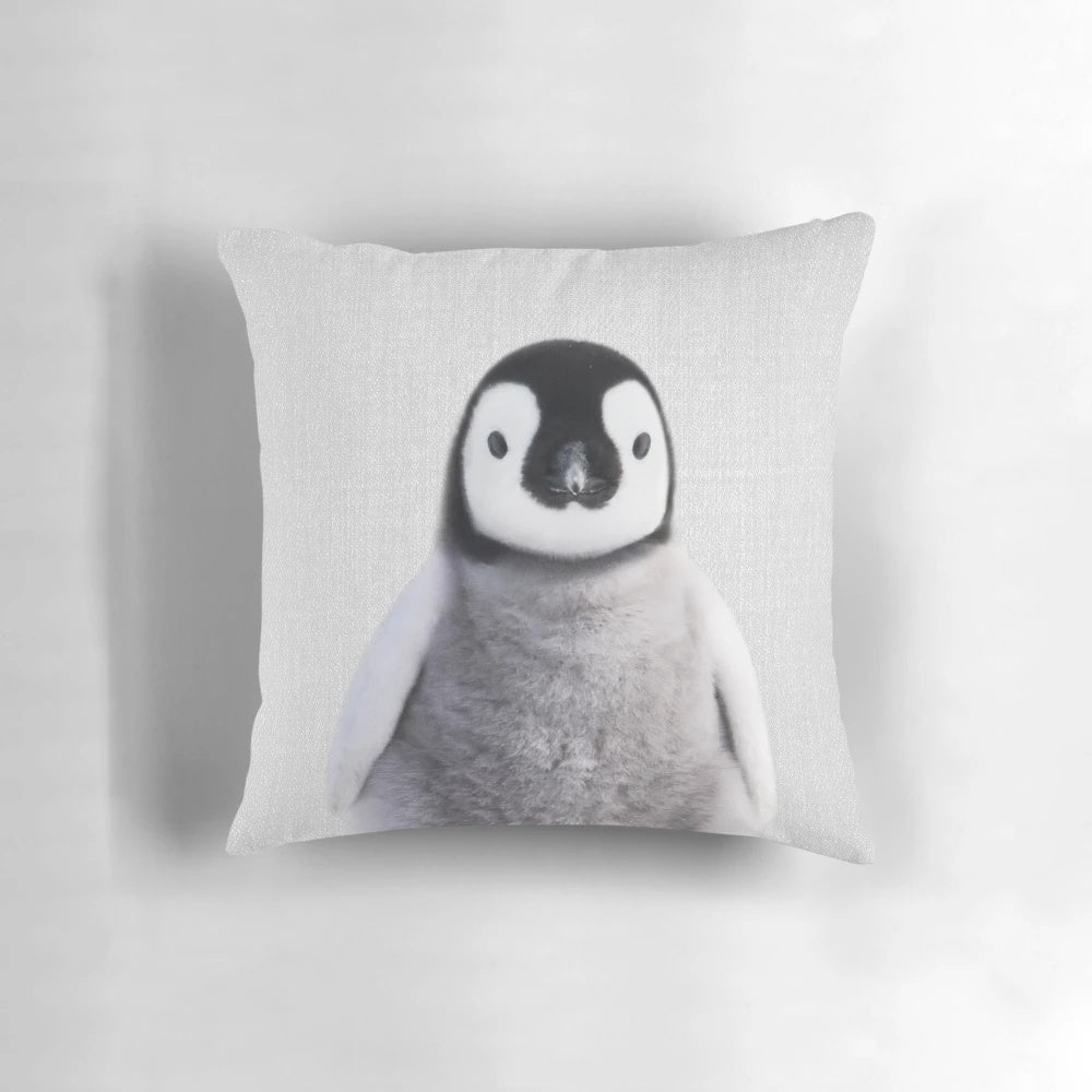 Colorful pillow featuring a playful baby penguin design, perfect for a modern nursery or children's space.