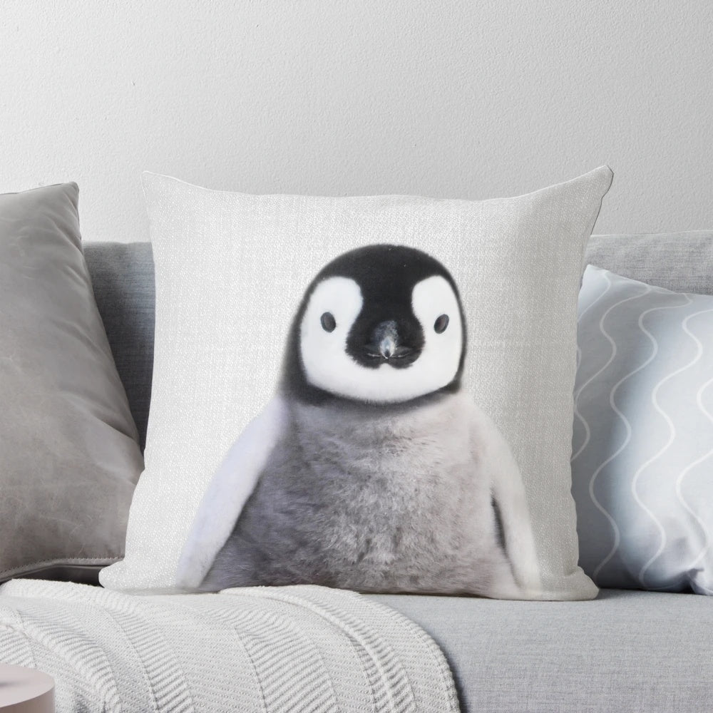 Colorful pillow featuring a playful baby penguin design, perfect for a modern nursery or children's space.