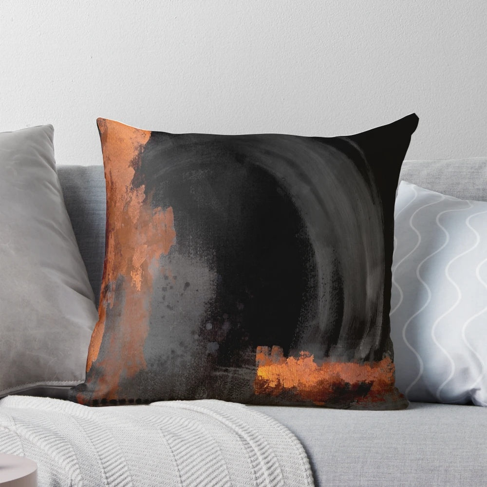 Black and orange abstract art design on a decorative throw pillow