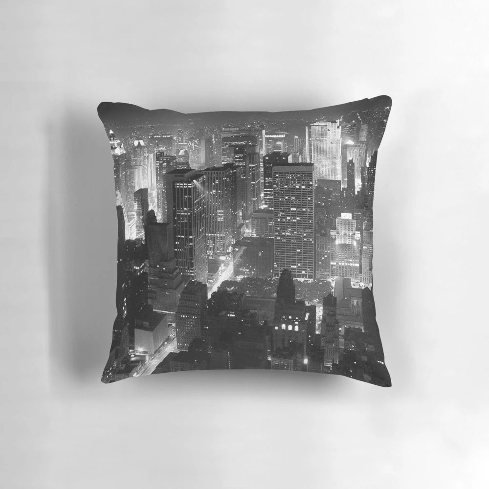 A monochrome image of the iconic Manhattan skyline at night, featuring skyscrapers and the bright lights of the city.