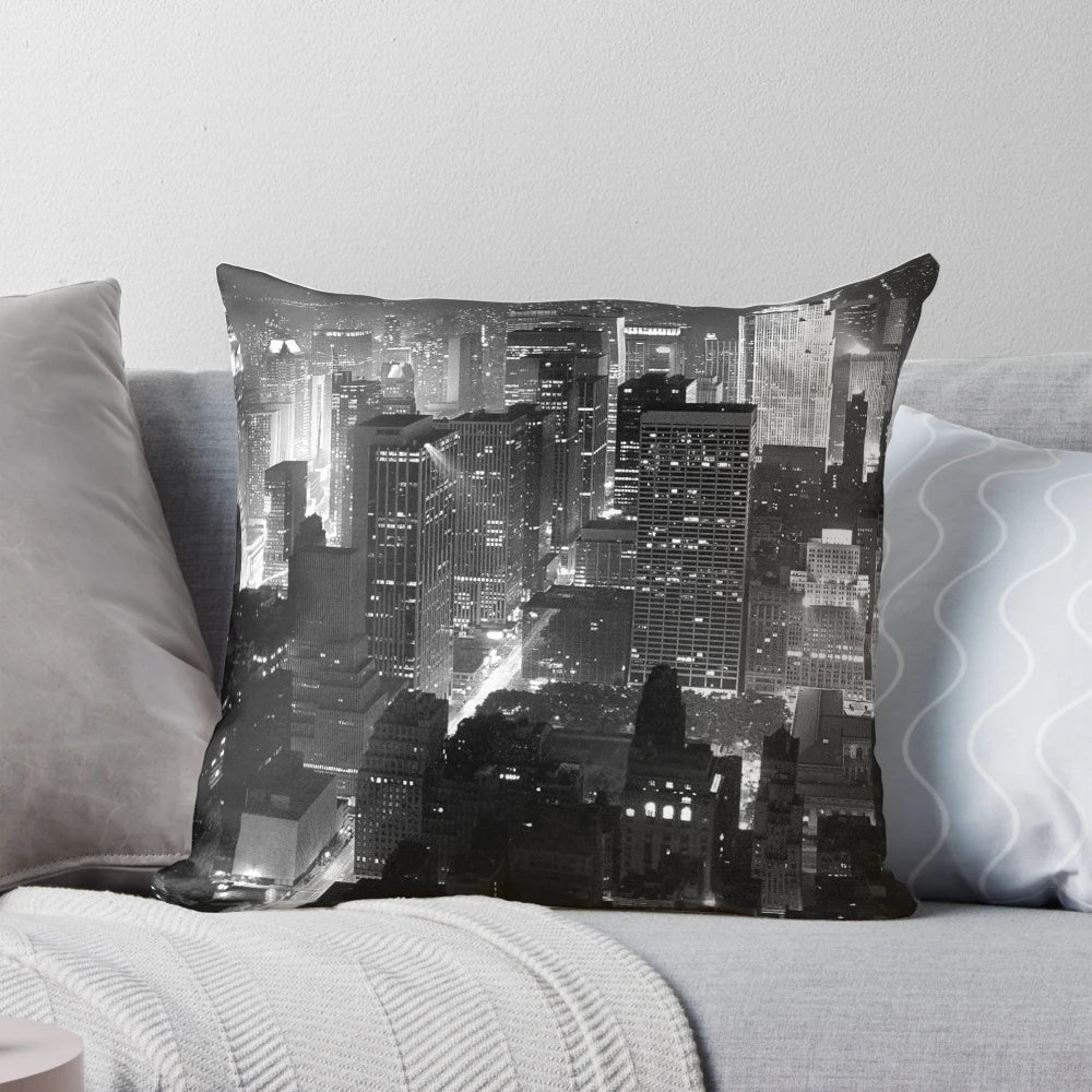 A monochrome image of the iconic Manhattan skyline at night, featuring skyscrapers and the bright lights of the city.