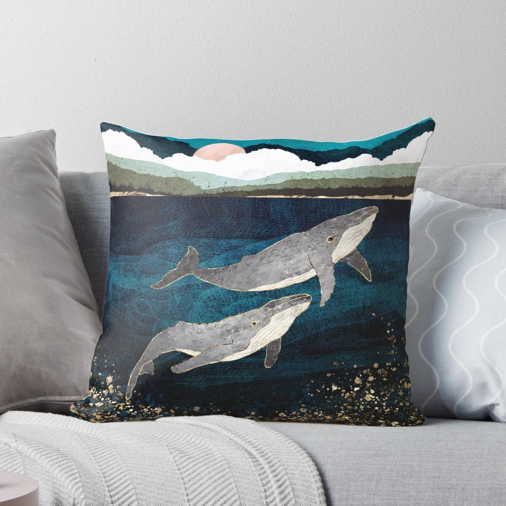 Pillow featuring a contemporary, abstract design of a whale pod in the ocean.