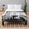 Plush blanket featuring a black and white image of a street scene in Brighton, England with a cinema and cars