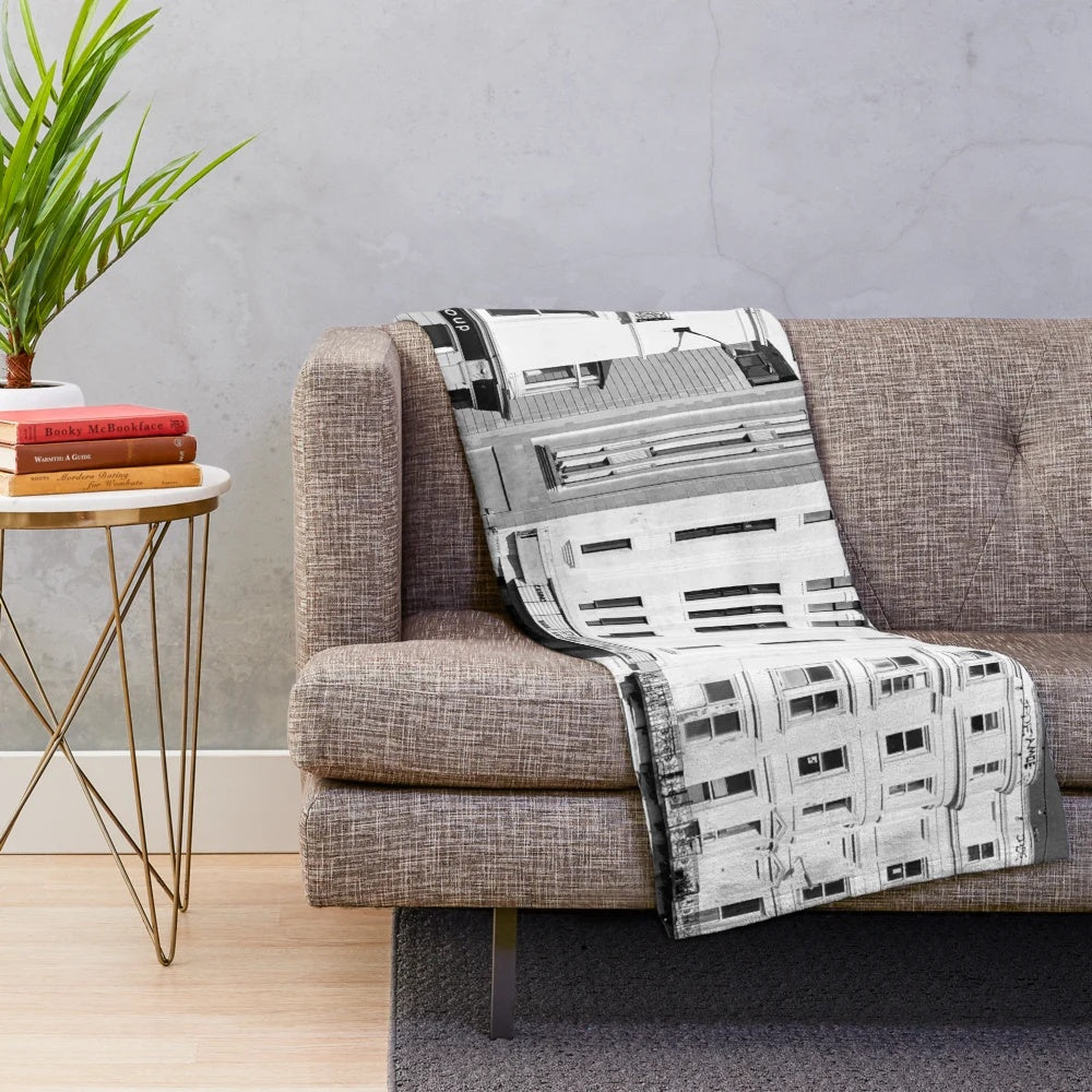 Plush blanket featuring a black and white image of a street scene in Brighton, England with a cinema and cars