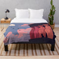 Caryatid figures at dusk on a soft, plush blanket
