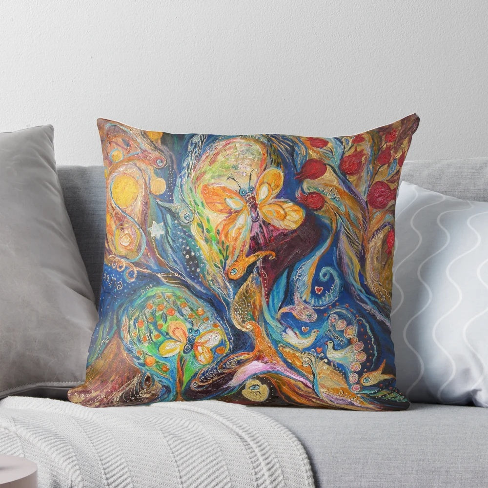 Vibrant Chagall-inspired pillow with abstract, spiritual symbols and Hebrew lettering.
