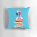 A vibrant pink flamingo perched atop a delectable doughnut-shaped pillow, creating a surreal and whimsical home accent.