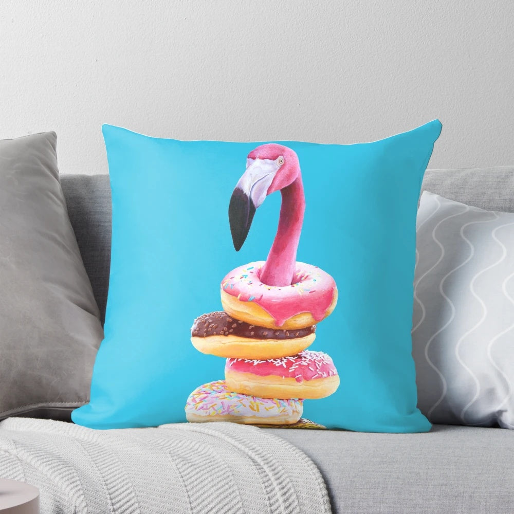 A vibrant pink flamingo perched atop a delectable doughnut-shaped pillow, creating a surreal and whimsical home accent.