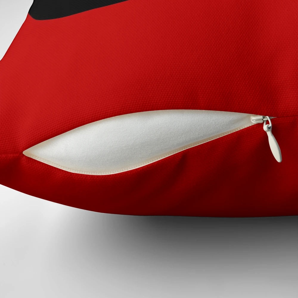 Pillow featuring a modern abstract design with black ellipses and white circles on a red background