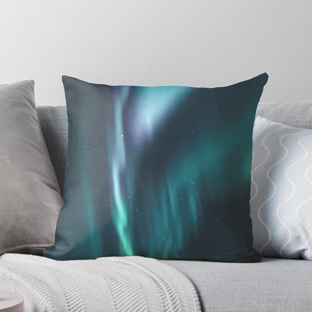 Vibrant blue and green northern lights illuminating a snowy night sky