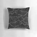 A black and white decorative pillow featuring a minimalist mountain landscape design.