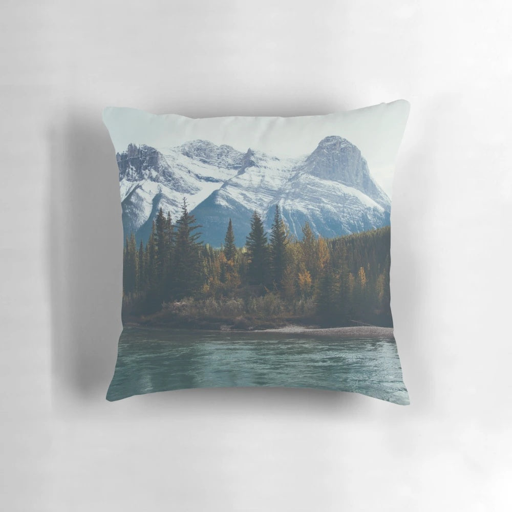 A beautiful pillow featuring a serene mountain river landscape in the Canadian Rockies