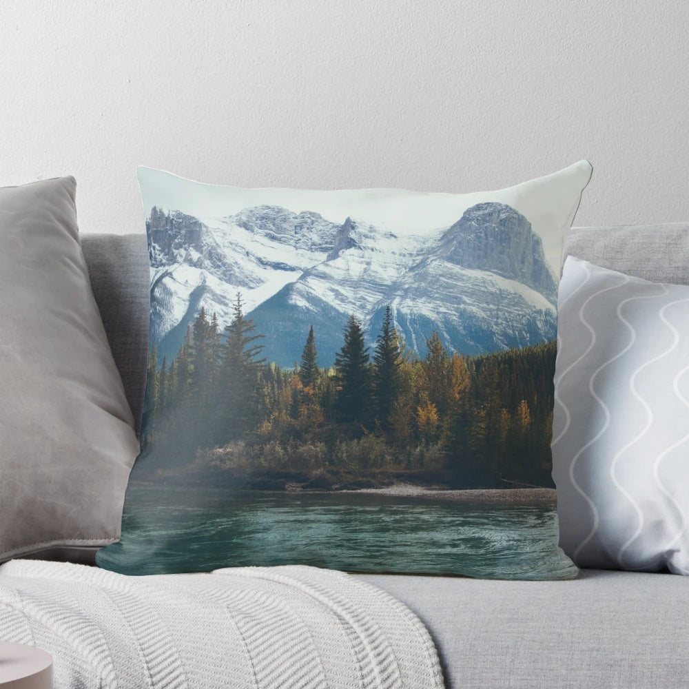 A beautiful pillow featuring a serene mountain river landscape in the Canadian Rockies