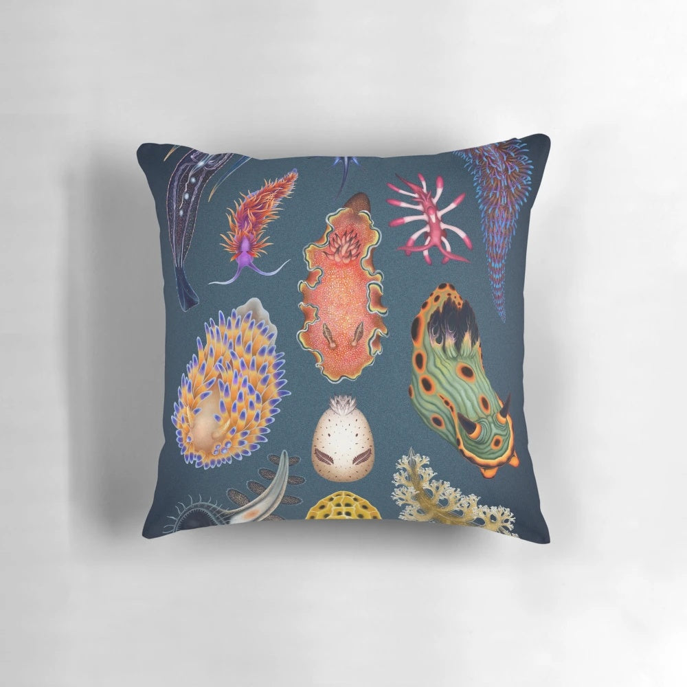 Vibrant nudibranchs (sea slugs) printed on a decorative throw pillow, showcasing the beauty of marine life.