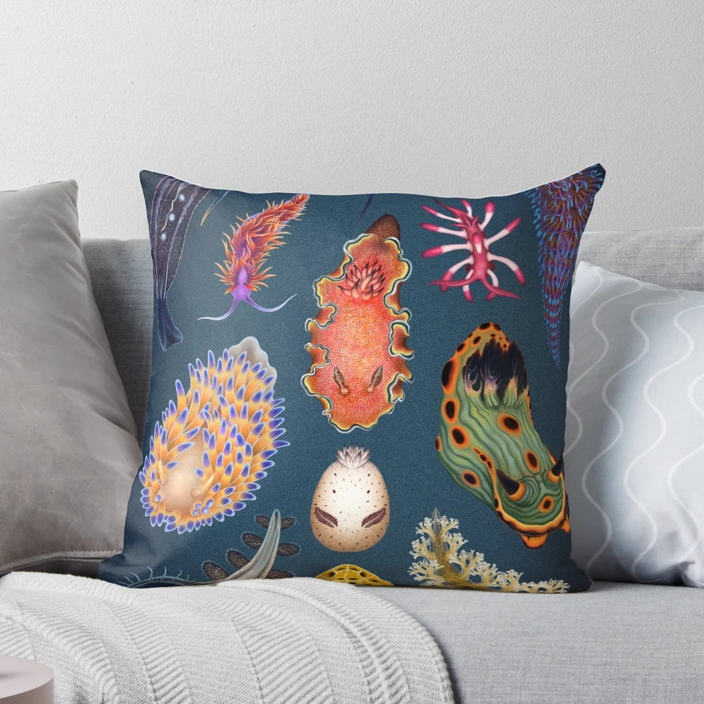 Vibrant nudibranchs (sea slugs) printed on a decorative throw pillow, showcasing the beauty of marine life.