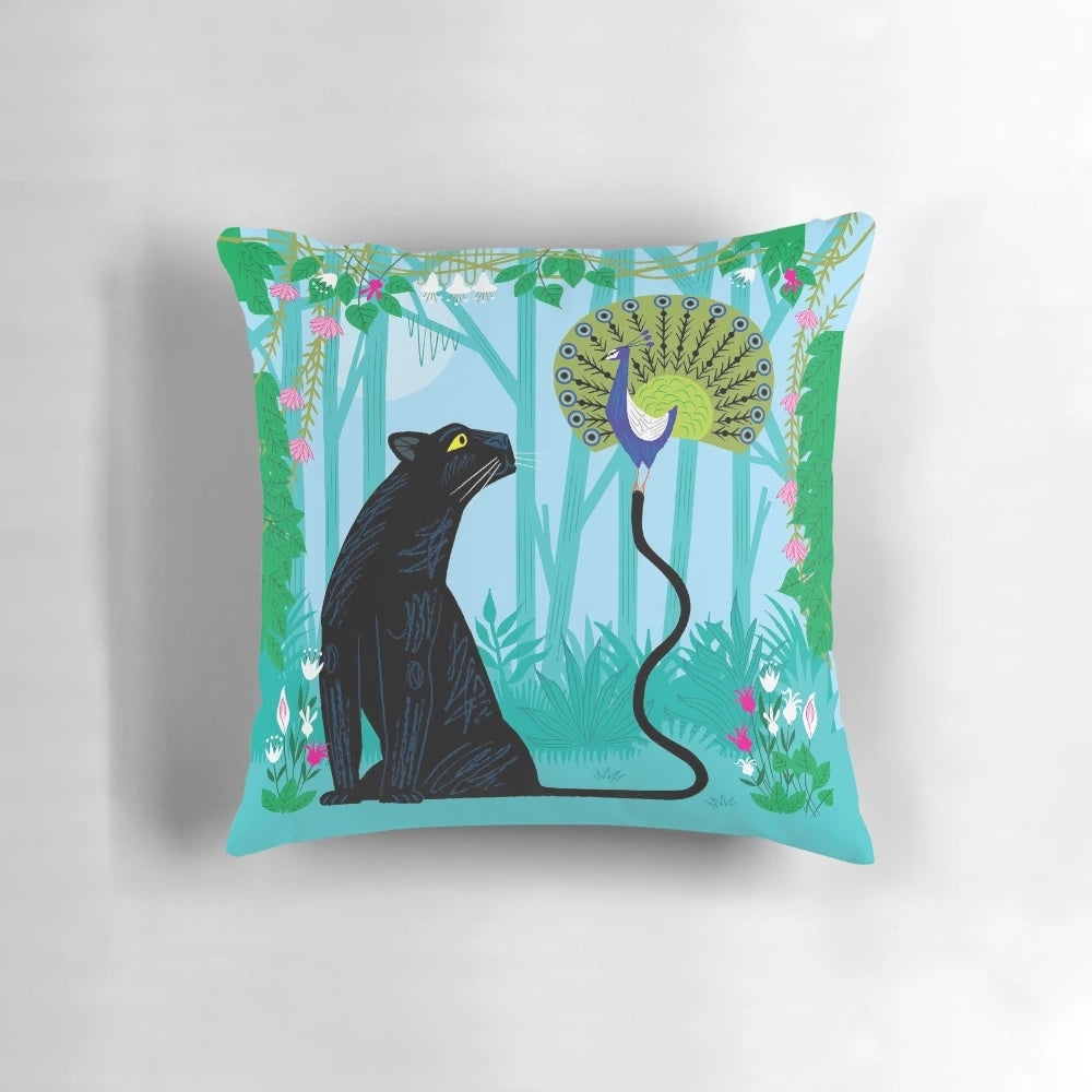 Colorful pillow featuring a peacock and panther in a lush jungle setting