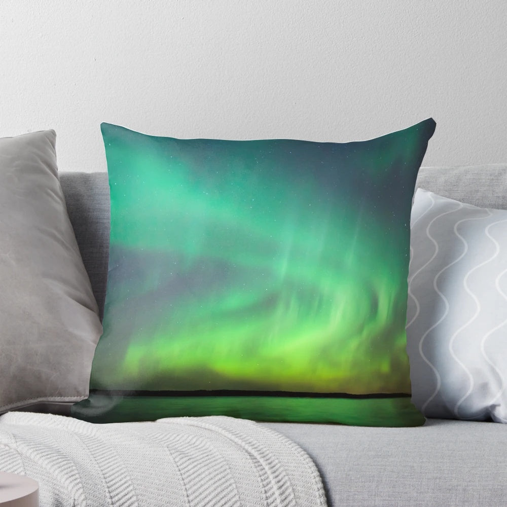 Pillow featuring a stunning image of the vibrant northern lights dancing over a serene Finnish lake