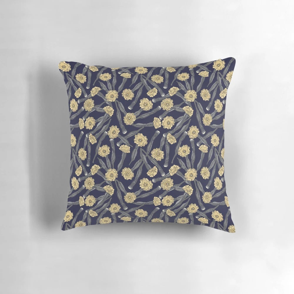 A close-up view of a yellow pistil flower on a dark background, showcasing the Pistil Pillow's captivating design.